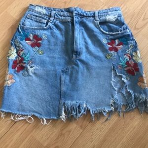 Distressed vintage denim skirt with floral design